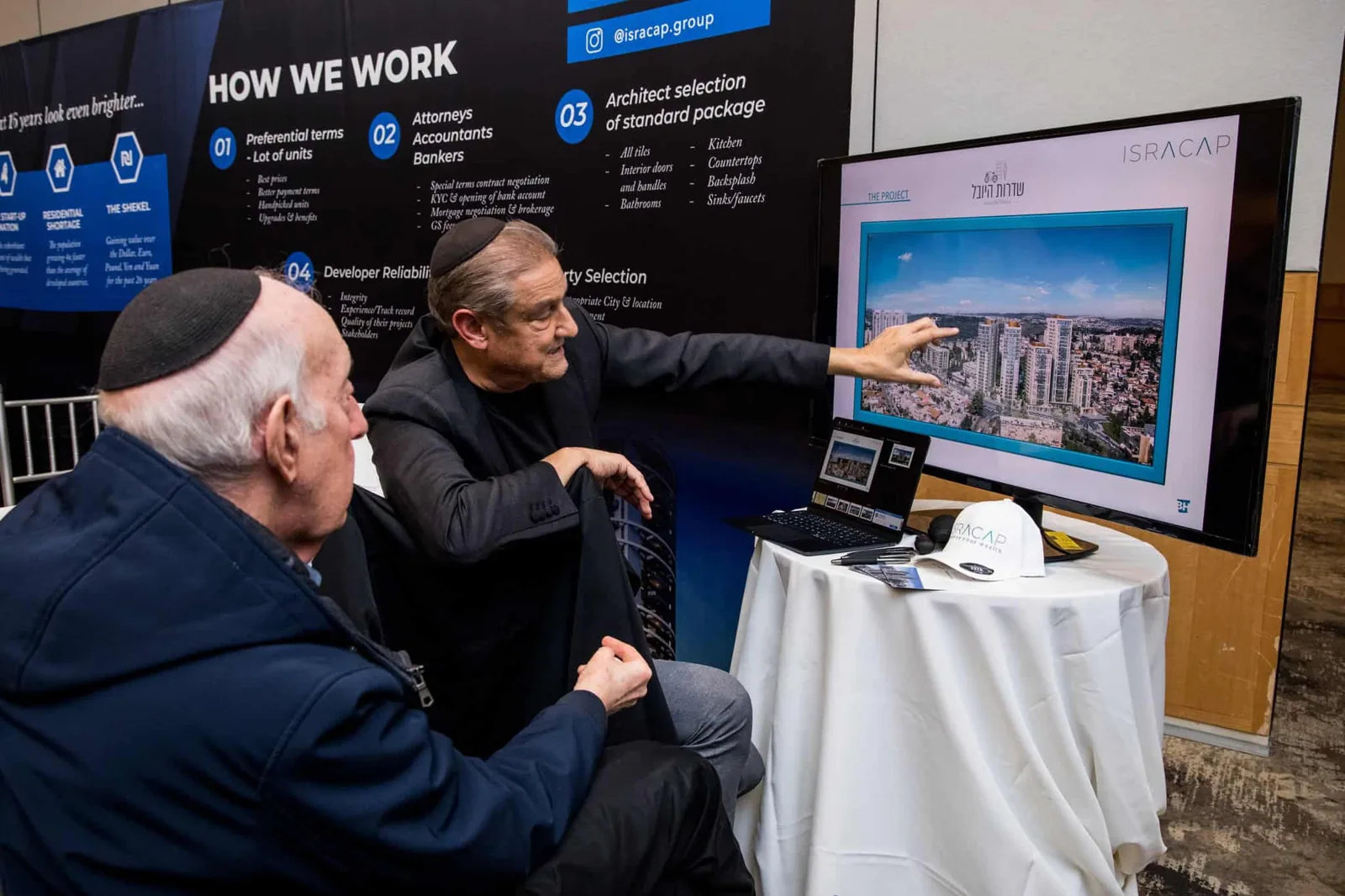 Visitors reviewing a project at the Home in Israel exhibition